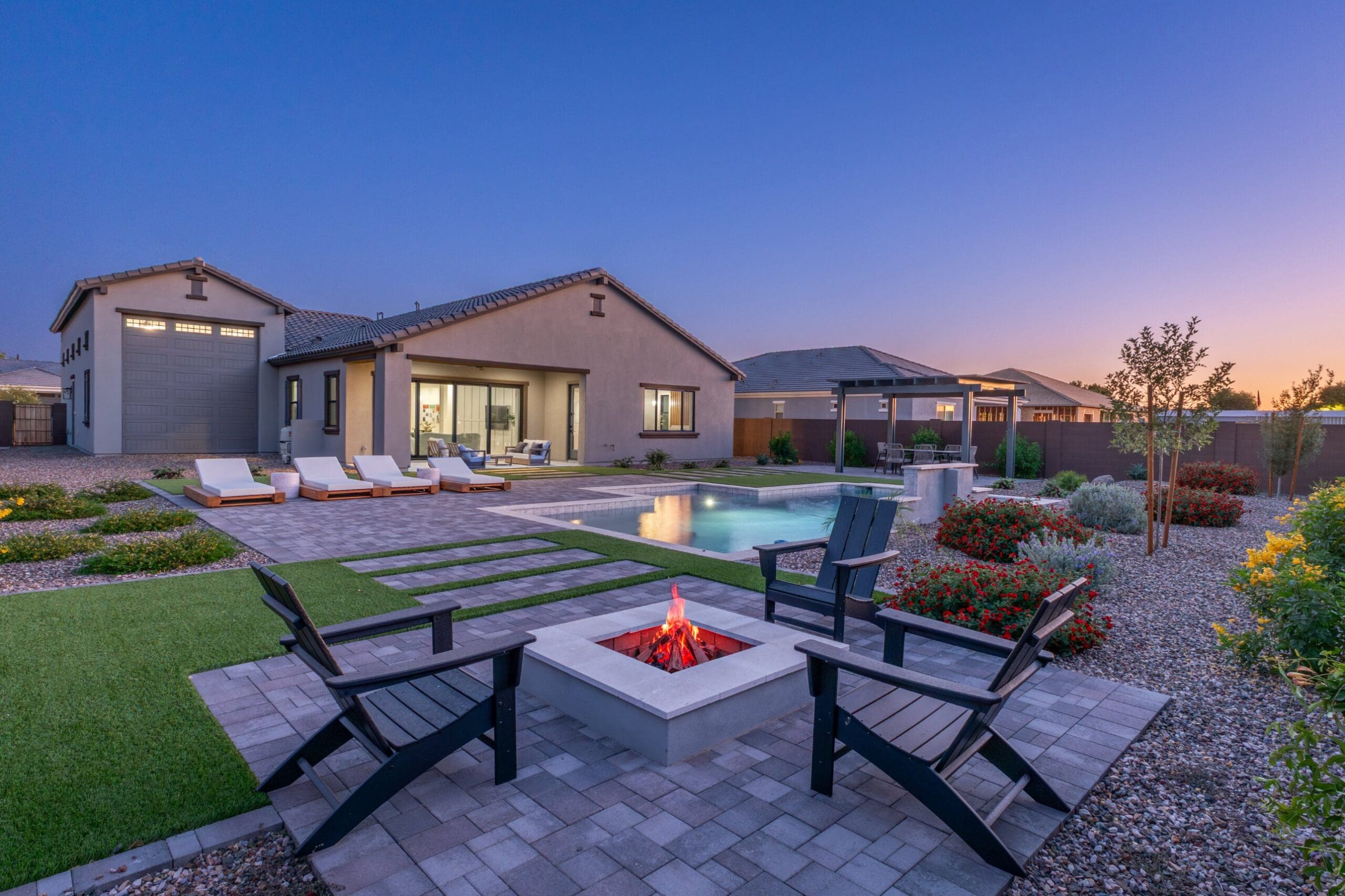 Acoma Estates Lot 7 backyard with pool and fire pit at twilight